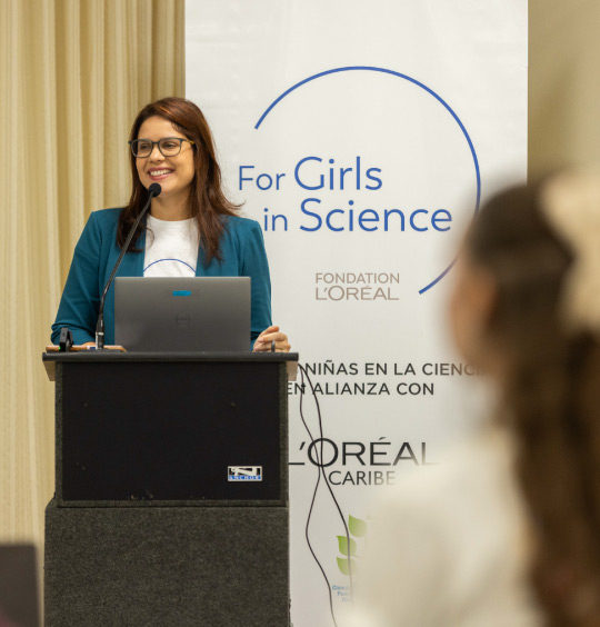 a photo of a woman speaking at a For Girls in Science event