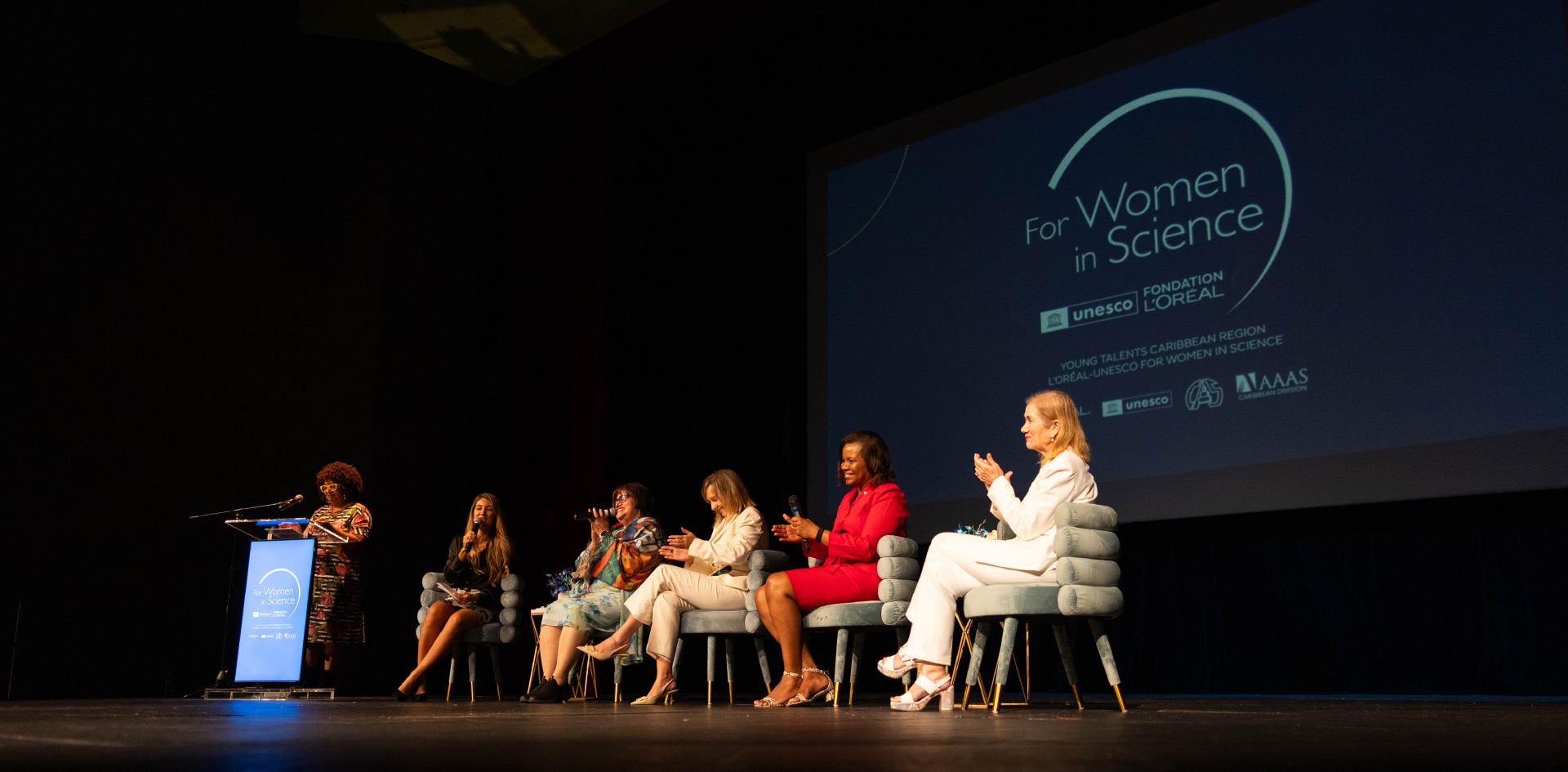 photo of 6 women, on stage, speaking at a For Women in Science event