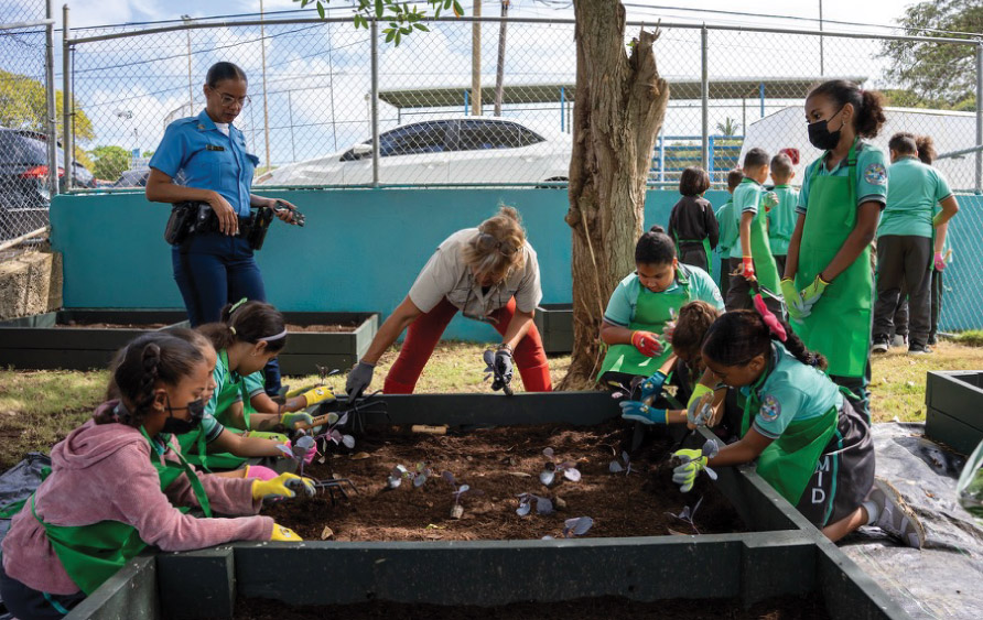 a photo of children and adults gardening
